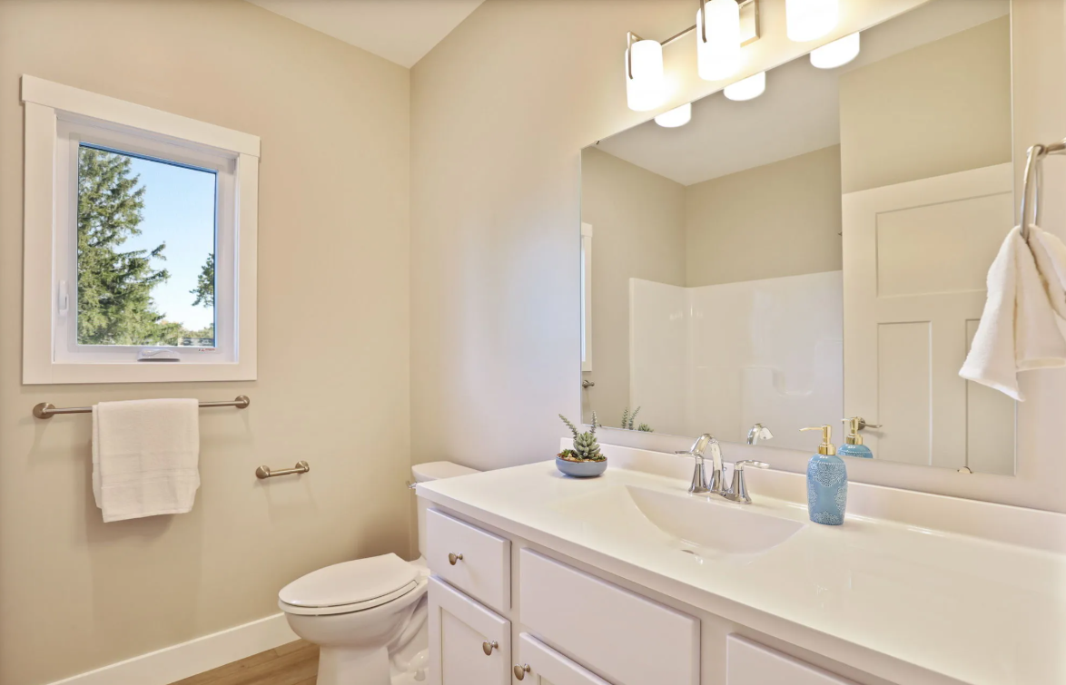 Bathroom with white cabinetry and modern fixtures